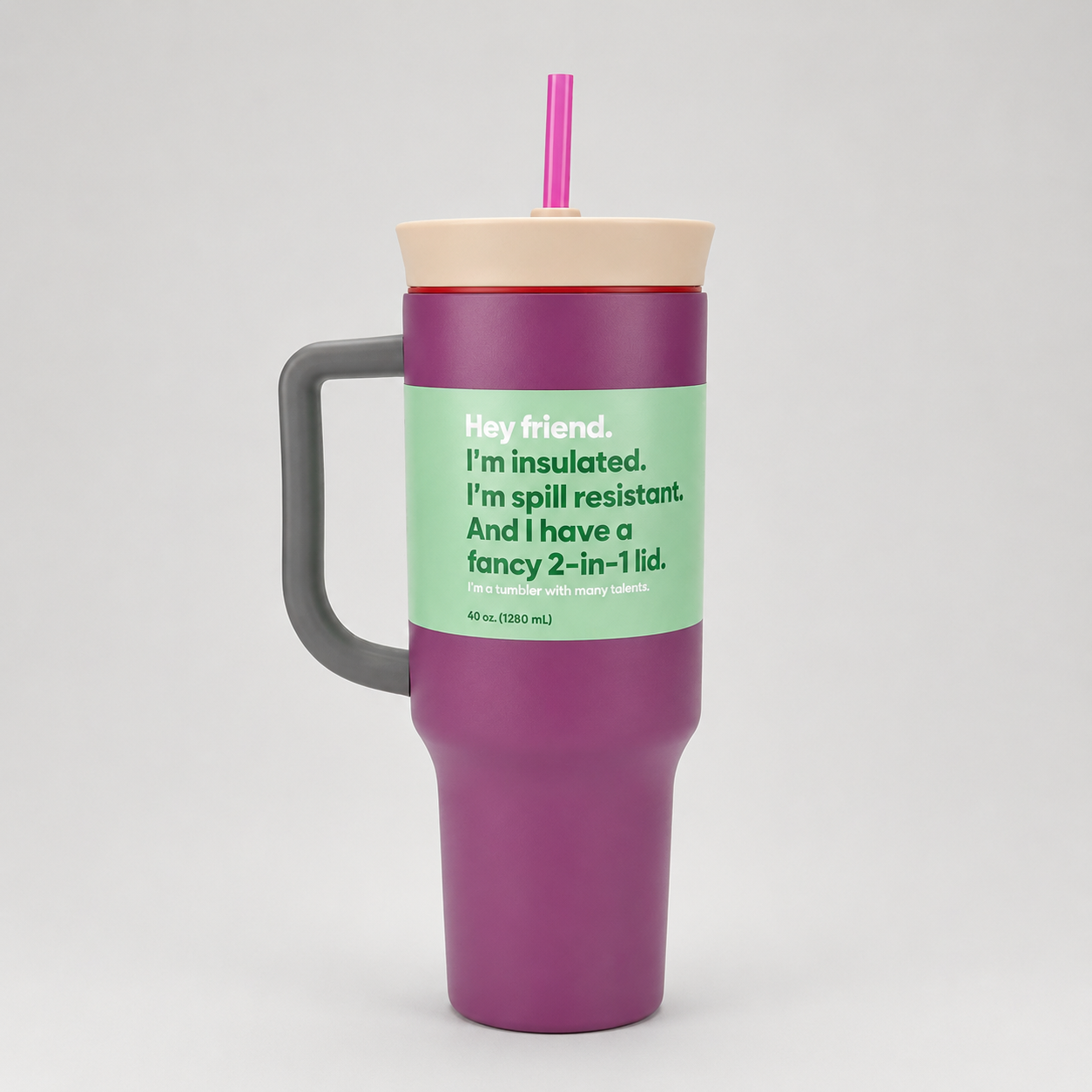 Purple insulated tumbler with a green label and pink straw on a white background