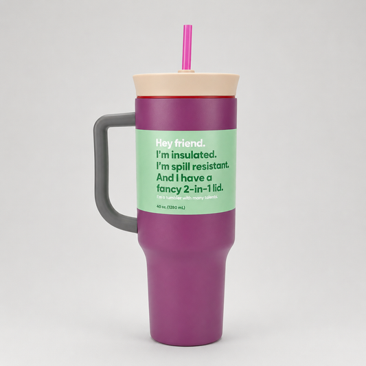 Purple insulated tumbler with a green label and pink straw on a white background