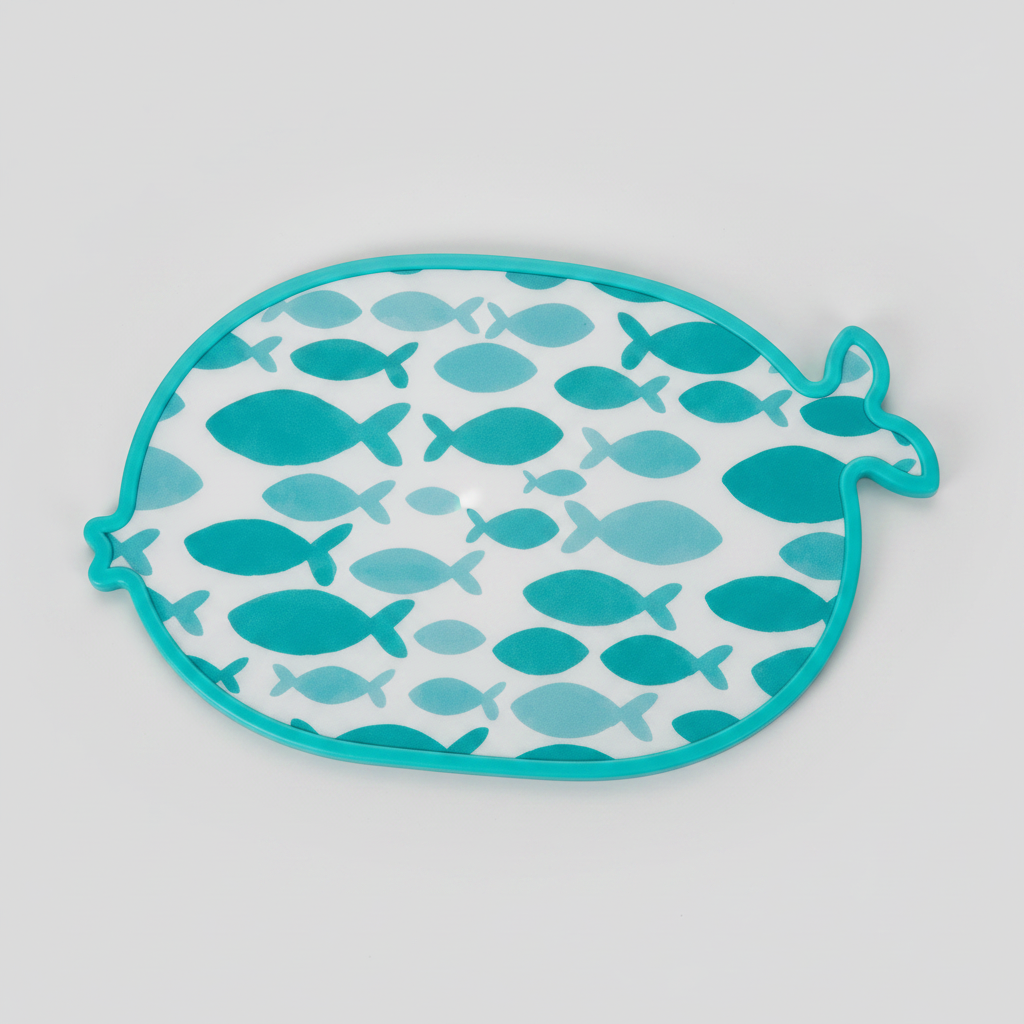 Fish-shaped teal cutting board on light gray background
