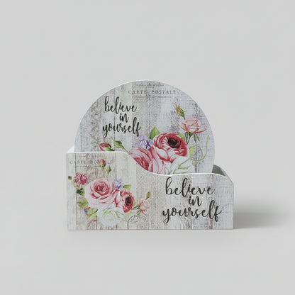 Decorative card holder with floral design and 'believe in yourself' text on a white surface.